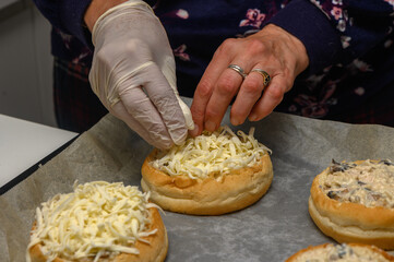 Preparing cheesy buns with care in a cozy kitchen during a joyous cooking session
