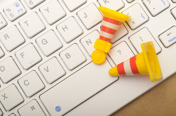 Safety Cones on Keyboard: Symbolizing Caution in Digital Workspaces