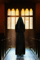 Monk standing inside a church. 