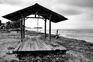 A gazebo in a black and white picture brings out the textures and shapes of the object into an...