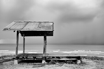 A gazebo in a black and white picture brings out the textures and shapes of the object into an...