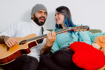 Latin married couple in love on Valentine's Day. Man dedicating romantic song to his wife. People...