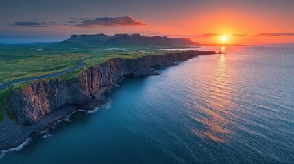 Fototapeta premium A stunning coastal sunset over cliffs and calm waters, highlighting natural beauty.