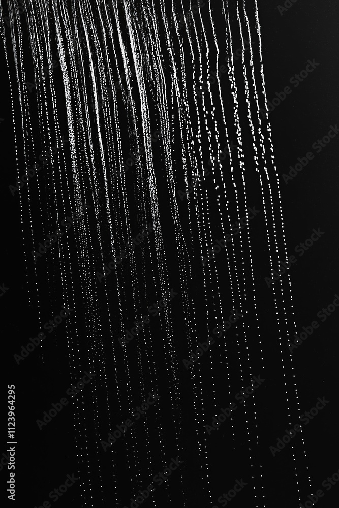 Poster water droplets cascade in a mesmerizing pattern against a dark background