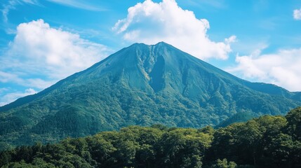 Majestic Mountain under a Summer Sky: A Breathtaking View of Lush Greenery and Blue Skies