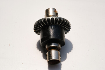 Closeup Remote Control Car Differential Gear isolated on white. Metal Gear parts allowing the...
