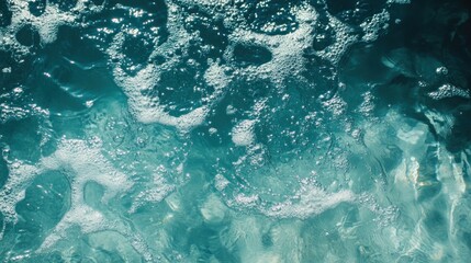 Close-up of turquoise water with white bubbles and foam.