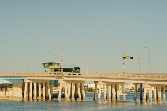 Editorial Use Only,  December 7, 2024. St. Pete Beach, FL, USA. View from over intercoastal  towards Corey Causeway Drawbridge with a SunRunner Bus Rapid Transit coming down. Late afternoon sun near s