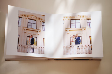  an open photo book with wedding photos on a white table