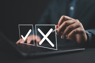 Check wrong and right marks for business options on a laptop. Yes or no decisions concept. Decide...