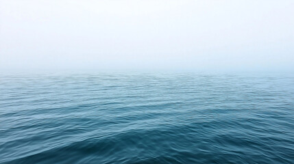 Fototapeta premium Ocean Mist: A tranquil, misty scene of the vast ocean, with gentle waves and a serene blue hue, evoking a sense of peace and tranquility. 