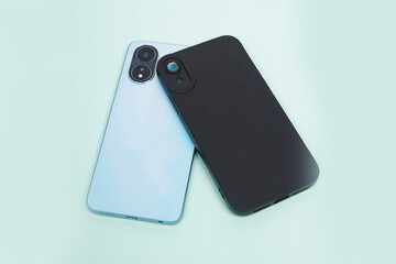 Blue smartphone and black case isolated on blue background. High resolution photo.