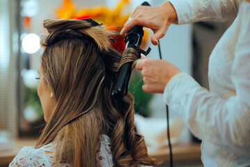 Hairdresser Using Hair Curler for Special Day Hairstyle. Hairstylist using curling iron to make a...
