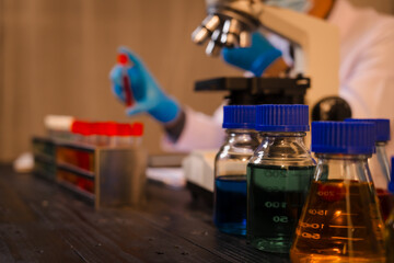 A man works at his desk, reviewing blood lab test results with focus and precision, analyzing data for accuracy and providing critical insights for medical diagnostics and patient health evaluations.