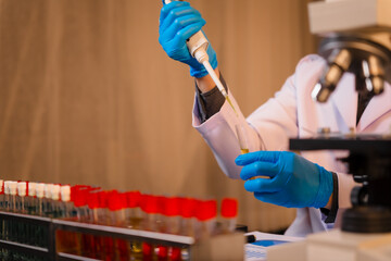 A man works at his desk, reviewing blood lab test results with focus and precision, analyzing data for accuracy and providing critical insights for medical diagnostics and patient health evaluations.