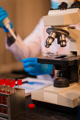 A man works at his desk, reviewing blood lab test results with focus and precision, analyzing data for accuracy and providing critical insights for medical diagnostics and patient health evaluations.