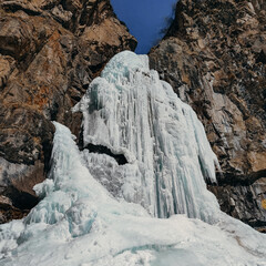 beautiful frozen waterfall in the mountains
