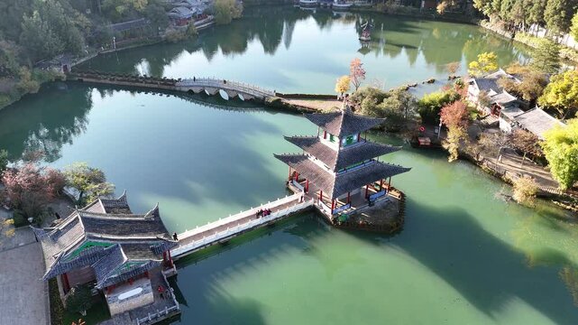 The park has morning activities. Black Dragon Pool is a park where in the morning you can see the reflection of the Jade Dragon Snow Mountain in the pond in Lijiang City, China.