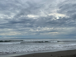 Ocean's Embrace: A Serene Coastal View Beneath a Dramatic Sky