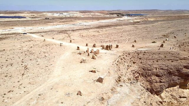 Drone  view of large boulders arranged in specific pattern at public sculpture park in desert on cliff above Judean Desert near Mitzpe Ramon in southern Israel.