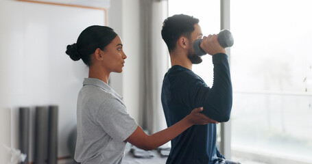 Health, man and woman in physiotherapy with dumbbell for fitness, muscle workout or exercise. Rehabilitation, physiotherapist and patient in office together for help, strength or mobility training