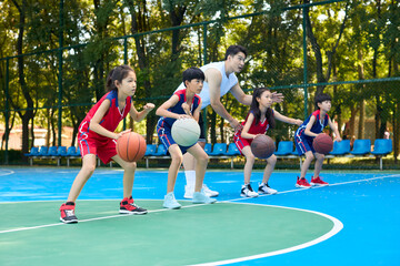 Chinese Kids Warming Up During Basketball Training Class