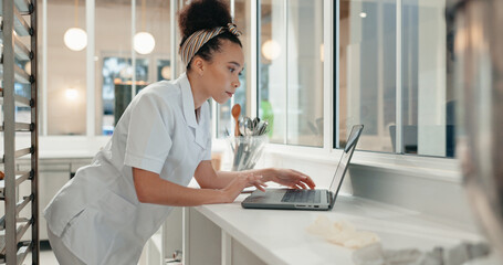 Research, reading and laptop with chef in kitchen for online recipe, restaurant review and food industry. Cafe, menu planning and cooking website with person in coffee shop for nutritionist.