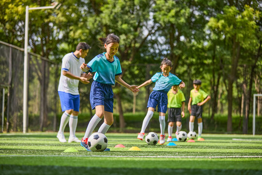 Chinese Coach and Kids in Football Training Class