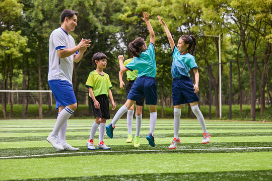 Chinese Coach and Kids in Football Training Class