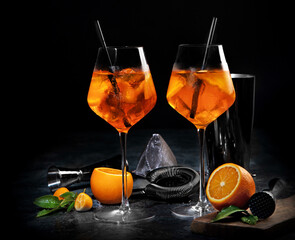 Aperol spritz cocktail served on dark background.