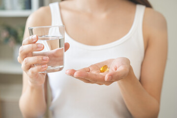 Dietary supplement, asian young woman, girl hand holding medical pill capsule, take or eat vitamin...