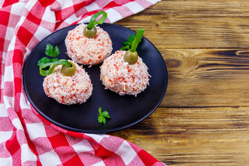 Appetizer of crab-cheese balls made in a shape of Christmas baubles on wooden table