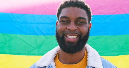 Man, portrait and happy at rainbow flag for pride, human rights and LGBT awareness in Brazil....