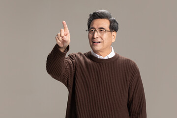 Portrait of senior Chinese man pointing