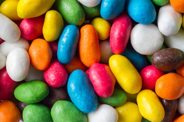 Bright multi-colored candies. Round dragee top view. Sweet colored spherical candies