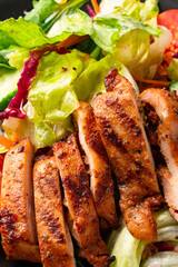 Salad and grilled chicken prepared for healthy nutrition