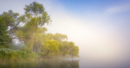 Misty morning with a lake and trees in the background