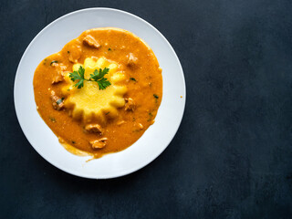 Pork ragout stew goulash with polenta on a white plate