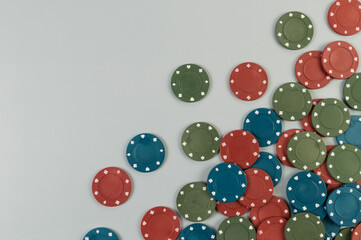 Top view of poker chips on grey background. Lot of gambling chips. Board game, playing cards, poker, casino. Copy space, flat lay.