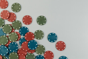 Top view of poker chips on grey background. Lot of gambling chips. Board game, playing cards, poker, casino. Copy space, flat lay.