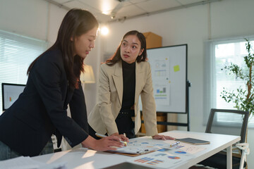 Group of business people, investors talking and meeting using documents and laptops to analyze and discuss. Presentation of financial report situation in the office. Teamwork concept, startup business