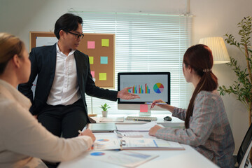 Group of business people, investors talking and meeting using documents and laptops to analyze and discuss. Presentation of financial report situation in the office. Teamwork concept, startup business