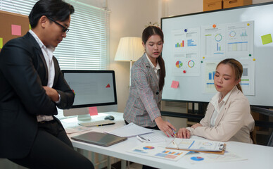 Group of business people, investors talking and meeting using documents and laptops to analyze and discuss. Presentation of financial report situation in the office. Teamwork concept, startup business