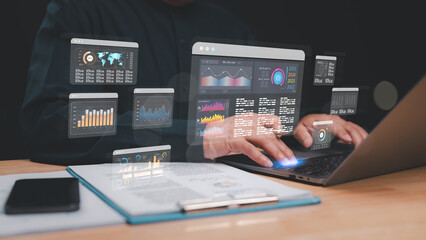 Professional analyzes multiple data visualizations on laptop, integration of technology and analytics in modern business environments for informed decision-making