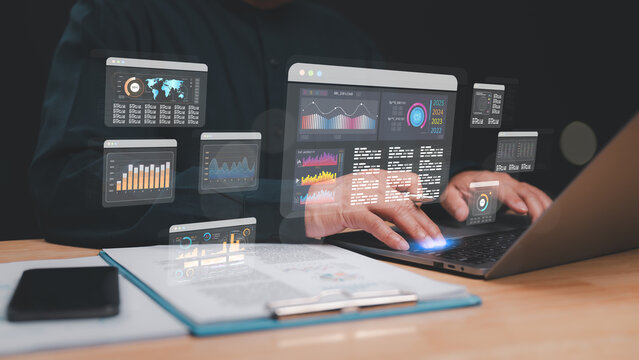 Professional analyzes multiple data visualizations on laptop, integration of technology and analytics in modern business environments for informed decision-making