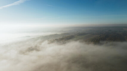 Misty hills with autumn trees