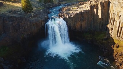 Majestic Waterfall Cascading Down Rocky Cliffs in a Serene Natural Landscape