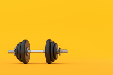 Adjustable dumbbell lying on yellow background for fitness