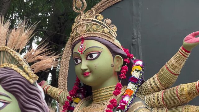 A close-up view of the green face of Maa Durga idol, highlighting its intricate details.