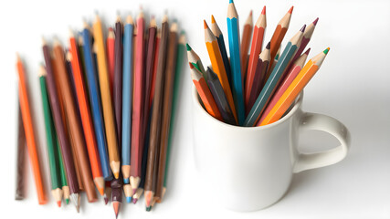 Fototapeta premium A ceramic coffee mug filled with colorful pencils, isolated on white